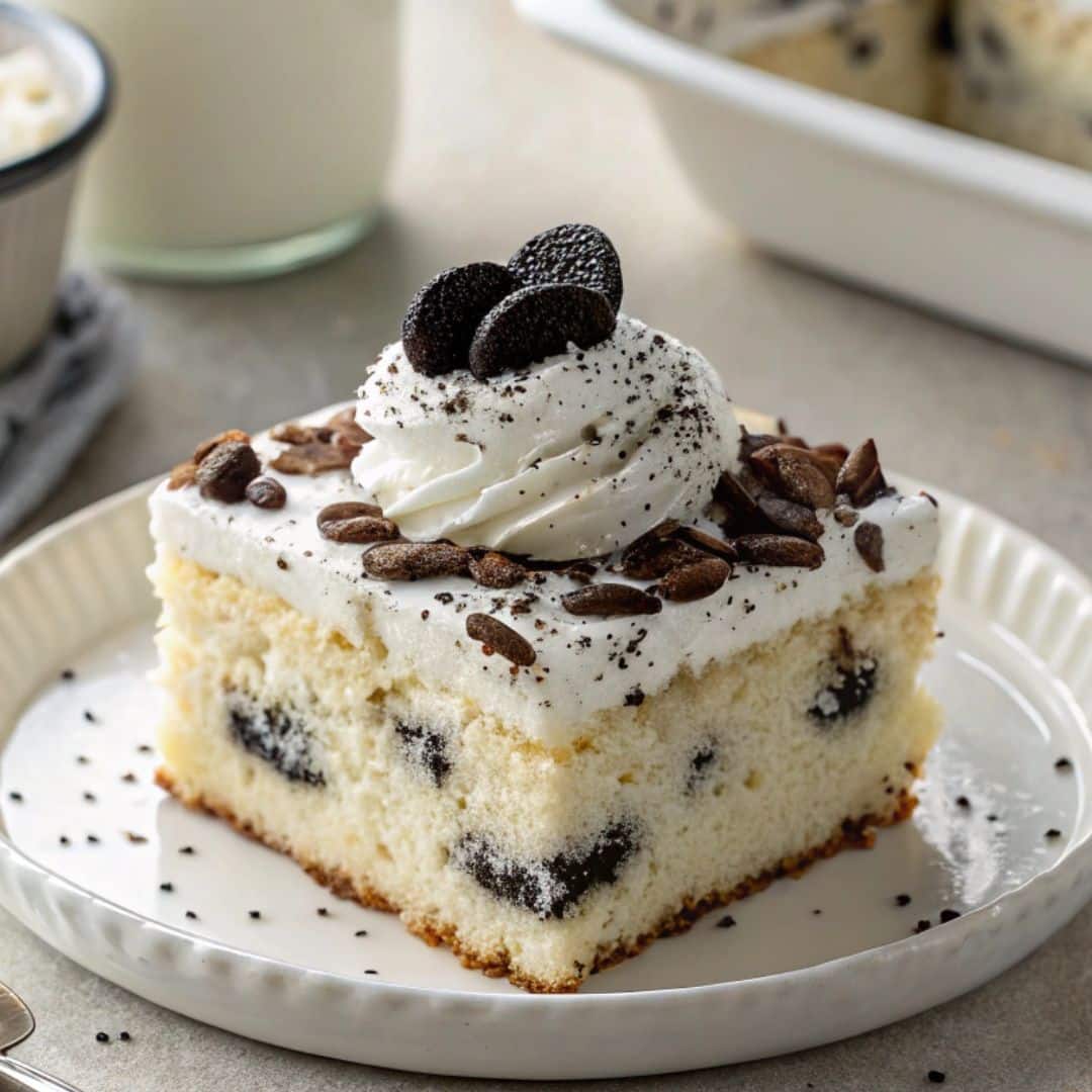 cookies & cream tres leches cake slice with Oreos