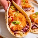 crispy air fryer bang bang shrimp tacos with creamy sauce and cabbage slaw