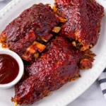 Tender slow cooker BBQ beef ribs with a sticky caramelized glaze. Easy comfort food perfect for dinner or gatherings.